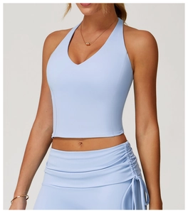 Close-up of light blue V-neck sports vest and ruched skirt in high-elastic yoga fabric