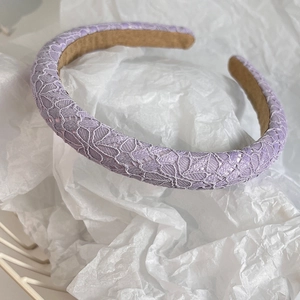 Detail of lavender lace headband showing intricate floral pattern and anti-slip lining
