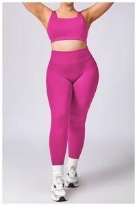 Detail of high-stretch magenta yoga set featuring a racerback bra and high-waist leggings