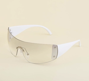Detail of white y2k frameless sunglasses featuring star rivet and brown gradient lens