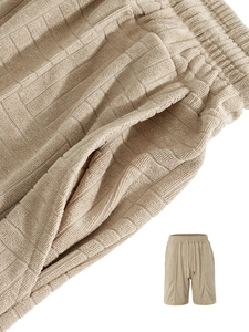 Detail of men's casual shorts showing waffle knit texture and drawstring waistband