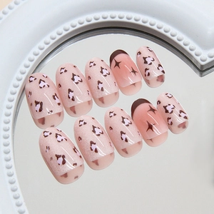 Pink cat-eye press-on nails with leopard heart and French tip design in 10-piece set
