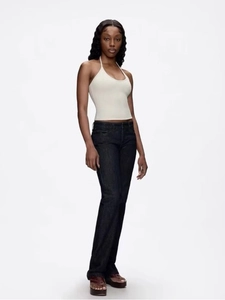 White halter neck camisole top with dark blue slim flare jeans and brown platform sandals