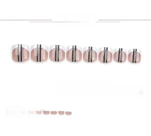Detail view of French style square toe fake nails with black stripes and silver glitter