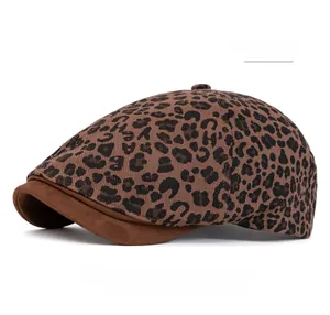 Detail of coffee leopard print flat cap with brown suede brim and twill fabric texture