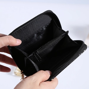 Interior detail of a black multifunctional wallet showing card slots and coin pocket