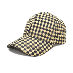 Detail of classic houndstooth baseball cap with textured tweed fabric and curved brim