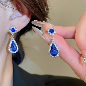 Elegant silver drop earrings with deep blue waterdrop gemstone and floral diamond accents