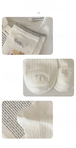 Detail view of white mesh knit socks showing elastic ribbed cuff and smooth toe seam