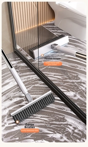 Close-up of floor brush with dense bristles and a flexible squeegee for bathroom cleaning