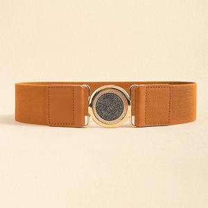 Detail of tan elastic waist belt with gold round buckle and textured black inlay