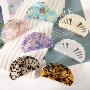 Set of six shell shaped acetate hair claws in various marble and tortoiseshell patterns