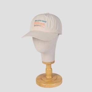 Macro shot of breathable beige nylon baseball cap with embroidered success rate letters