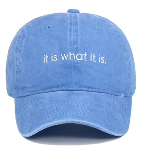 Close-up of it is what it is embroidery on sky blue washed cotton baseball cap