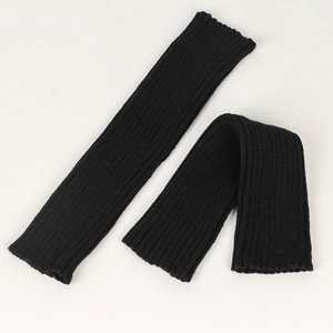 Close-up of black ribbed knit leg warmers showing texture and flexible thickness details