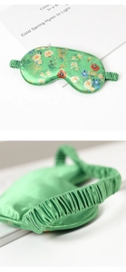 Detail view of green floral silk sleep mask with elastic strap and artistic painting