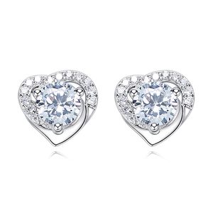 Detail of silver heart-shaped stud earrings with round center stone and crystal halo