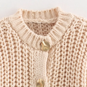 Chunky knit cardigan for women featuring unique irregular gold buttons in apricot color