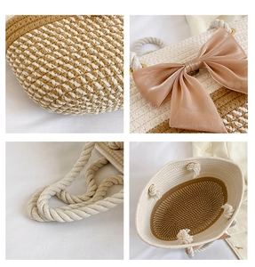 Detail view of woven straw tote bag featuring bow accents and brown contrast texture