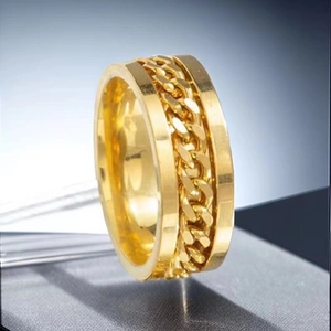Polished golden stainless steel spinner ring featuring a rotatable Cuban link inlay