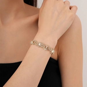 Detail of elegant gold bracelet with sparkling layered zircon crystals on a wrist