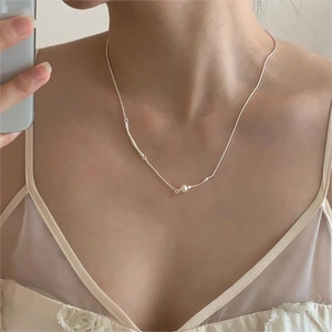 Macro view of 925 silver pearl necklace featuring sleek snake chain and bead textures