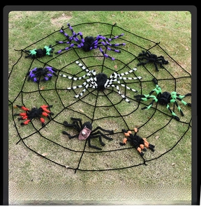 Detailed view of giant black spider web set with nine colorful fuzzy spiders for Halloween