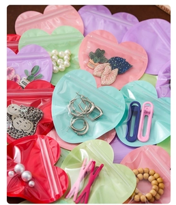Colorful heart-shaped resealable bags for jewelry storage in pink, green and purple