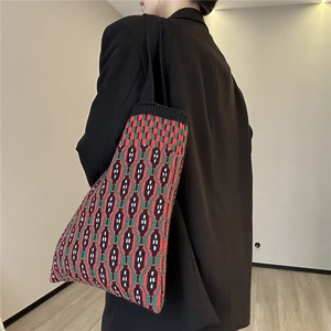 Close-up of red and green geometric knit tote bag with soft texture and retro pattern