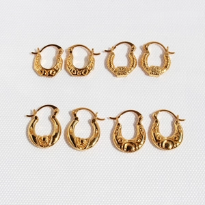 Set of four gold-plated vintage hoop earrings with embossed relief and geometric patterns