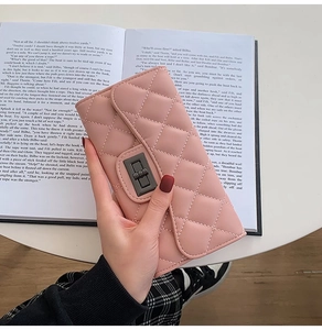 Pink quilted leather long wallet for women featuring a stylish metal twist lock buckle