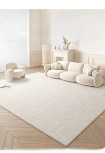 Detailed texture of cream-colored rectangular living room rug with fine edge stitching