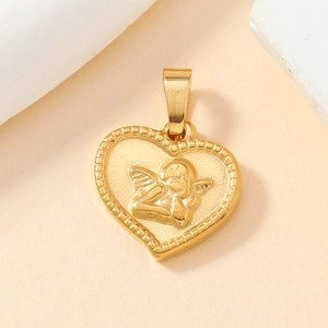 Macro shot of golden heart pendant featuring Cupid engraving and beaded edge details