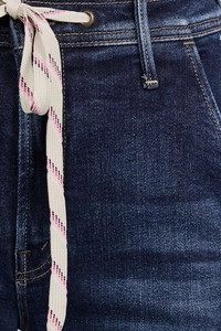 Close-up detail of the waist area and drawstring ties on these blue stretch denim pants