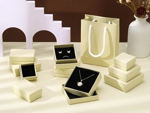 Detailed jewelry packaging set in pale green with gift bags and multi-size paper boxes