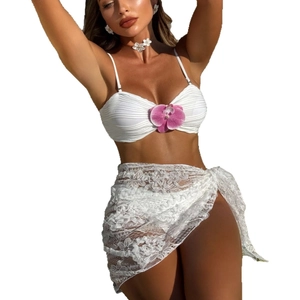 Three-piece white bikini set with floral orchid detail and lace sarong skirt