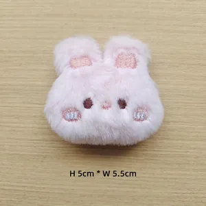 Pink plush rabbit head accessory with embroidered details measuring 5cm in height
