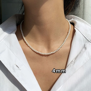 Detail showing 4mm natural pearl necklace on model with vintage French style finish