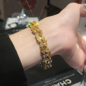 Detailed close-up of double-row yellow teardrop-cut zircon bracelet on wrist