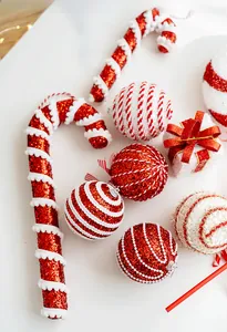 Macro detail of red glitter candy canes and striped Christmas ball ornaments