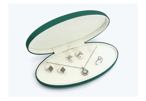 Detailed interior of dark green oval PU leather jewelry box for necklaces and earrings