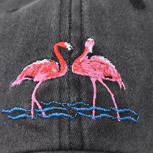 Washed black cotton baseball cap with intricate flamingo embroidery on the front panel