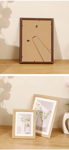 Minimalist wooden photo frame detail showing support stand and wall hanging hooks
