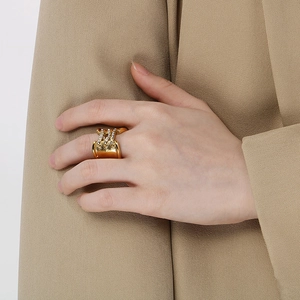 Detailed close-up of 18K gold plated wide band ring with crisscross pavé diamonds
