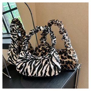 Chic zebra and leopard print cloud bags with pleated handles in a mirrored setting