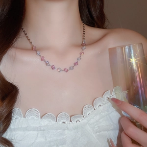 Detail of pink and white zircon square pendant necklace on model with silver chain