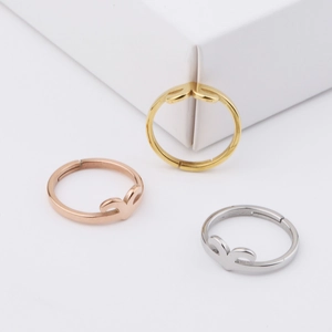 Three minimalist stainless steel open rings in gold, rose gold, and silver finishes