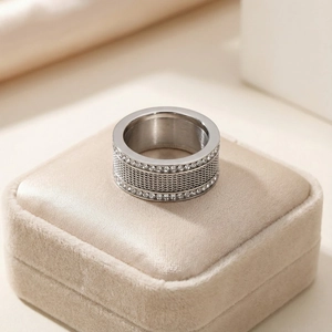 Detail of silver woven mesh ring featuring double row cubic zirconia on velvet box