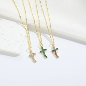 Minimalist curved gold cross pendants with white, green and colored zircon stones