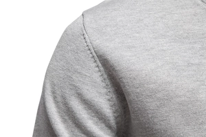 Macro shot of grey V-neck knit sweater shoulder seams and premium textured fabric